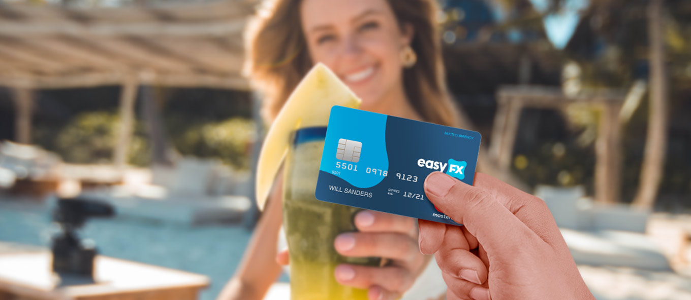 person using easyfx mastercard at the beach